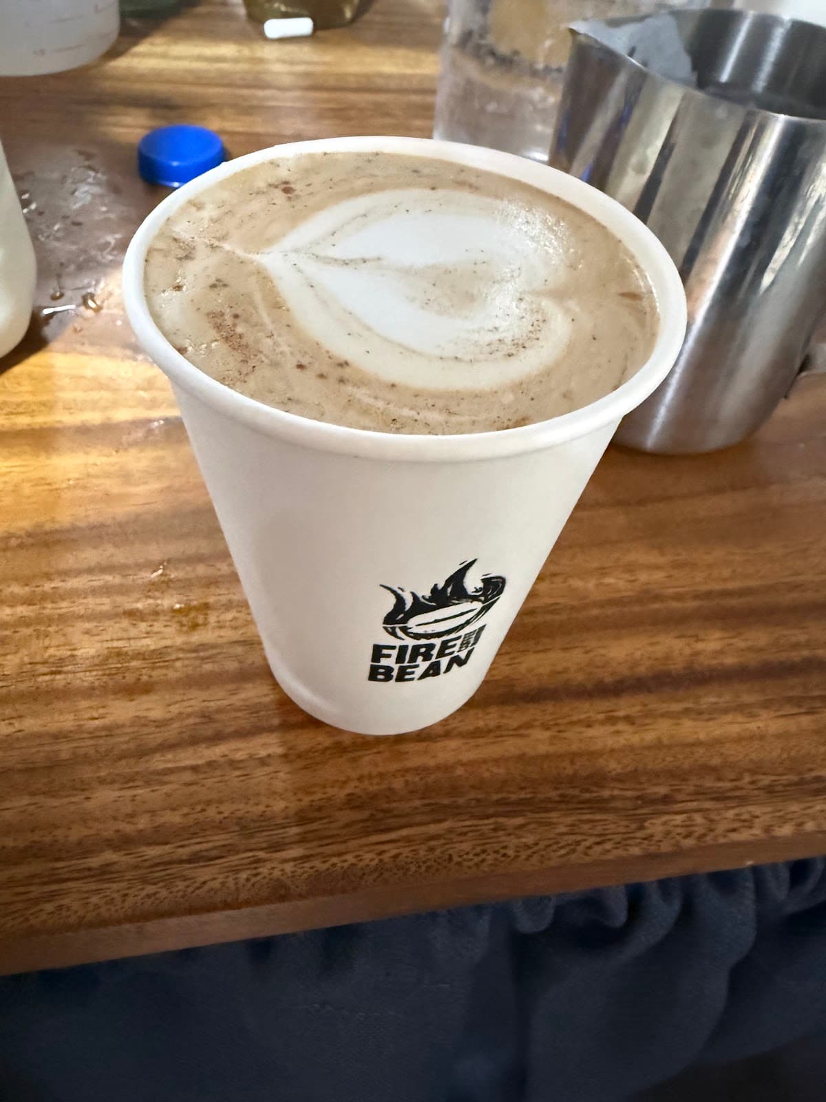 Fire Bean latte in a branded cup